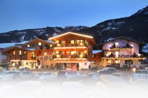 a large building with cars parked in a parking lot at Mara's Little Boutique Sleepover - Renovated in 2024 in Kaprun