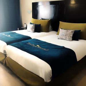 Postel nebo postele na pokoji v ubytování Palm Plaza Marrakech