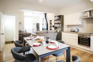 a kitchen and living room with a table and chairs at 107 and 109 Nunnery Lane in York