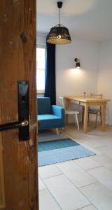 a living room with a blue couch and a table at Ferienwohnung am See in Ottersberg