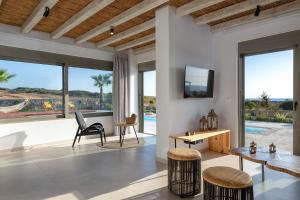 a living room with a view of the ocean at Anemos Villas in Lachania