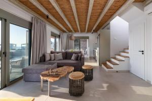 a living room with a couch and a table at Anemos Villas in Lakhania