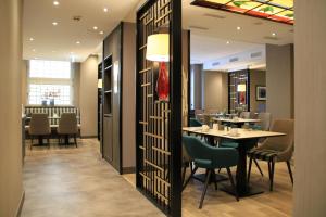 a dining room with a table and chairs at Hotel Lyskirchen in Cologne