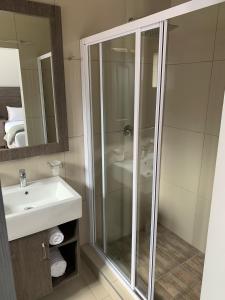 a bathroom with a shower and a sink at Airport lodge Newcastle in Newcastle