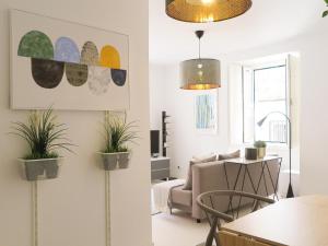 里斯本的住宿－Bica lisbon sunshine central bright and cozy apt，墙上挂着盆栽植物的客厅