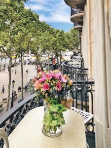 
a vase filled with flowers sitting on a balcony at Hotel Continental Barcelona in Barcelona
