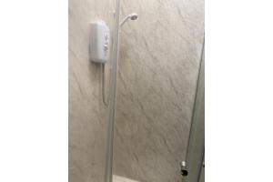 a shower stall with a phone on the wall at Newport Lodge in Newport