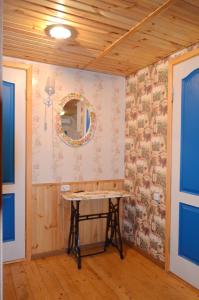 a room with a table and a wall with wallpaper at Cottages On Gdantsevskaya Street in Kryvyi Rih