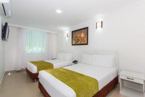 Postel nebo postele na pokoji v ubytování Hotel Bocagrande By GEH Suites