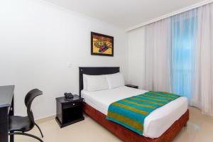 Postel nebo postele na pokoji v ubytování Hotel Bocagrande By GEH Suites