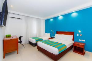 Postel nebo postele na pokoji v ubytování Hotel Bocagrande By GEH Suites