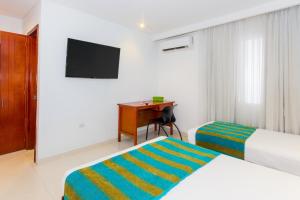 Postel nebo postele na pokoji v ubytování Hotel Bocagrande By GEH Suites