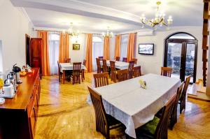 a dining room with a white table and chairs at Casa Alina in Deva