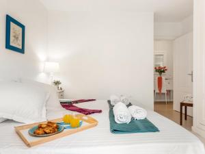 a tray of food on a bed with orange juice at 205 Los Cristianos by the beach, center, wifi AC in Arona