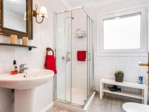 a white bathroom with a shower and a sink at 205 Los Cristianos by the beach, center, wifi AC in Arona +18 photos