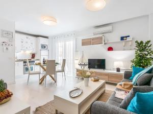 a living room with a couch and a table at 205 Los Cristianos by the beach, center, wifi AC in Arona