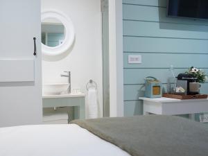 a bedroom with a bed and a sink and a mirror at The Three Hills in Bartlow