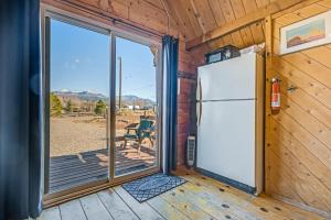 een koelkast in een kamer met een glazen schuifdeur bij Sunny Acres Cabin in Moab