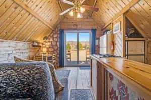 a kitchen and dining room of a cabin with a ceiling fan at Sunny Acres Cabin in Moab