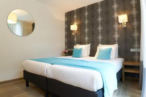 Postel nebo postele na pokoji v ubytování Alp de Veenen Hotel