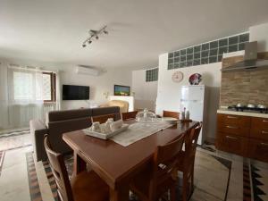 a kitchen and living room with a wooden table and a kitchen and a kitchen at B&B Le Rocce in Castel San Giorgio