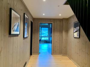 a hallway with wood paneled walls and a staircase at Fantastic apartment in Hemsedal, ski in ski out, Fyri Tunet in Hemsedal