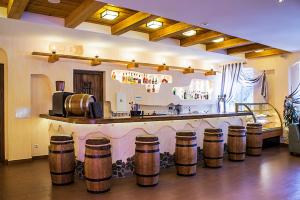 a bar with a bunch of wooden barrels in a room at Карпатські зорі SPAhotel in Yaremche