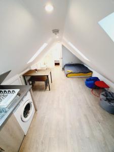 a room with a washer and dryer in a attic at Chelmsford Town Centre New Modern Apartments in Chelmsford