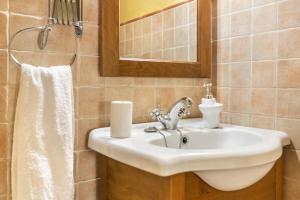 a bathroom with a sink and a mirror at Casa Irene in Teror +25 photos