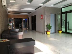 a lobby of a building with potted plants in it at Hotel Trihari in Rishīkesh