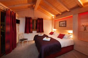 a bedroom with a large bed in a room at CHALET KAILA in Morzine