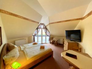 a bedroom with a bed and a tv in a room at Haus Belger in Großziethen