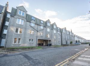 a row of buildings on the side of a street at Dwellcome Home Ltd 2 Bed Aberdeen Apartment - see our site for assurance in Aberdeen