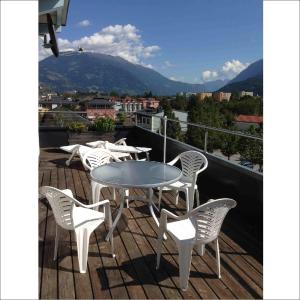 a table and chairs on a balcony with a view at FeWo Creativ-Center Lienz in Lienz