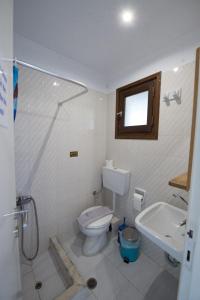 a bathroom with a shower and a toilet and a sink at Villa Spyridoula studios on the Beach in Sidari