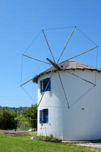 a windmill on the side of a field at Villa Spyridoula studios on the Beach in Sidari