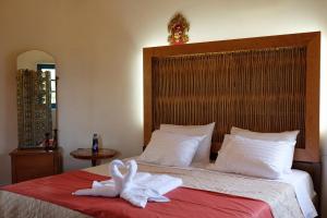 a bedroom with a bed with two towels on it at Villa Spyridoula studios on the Beach in Sidari