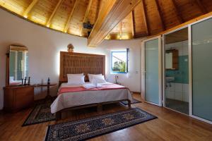a bedroom with a bed and a bathroom with a shower at Villa Spyridoula studios on the Beach in Sidari