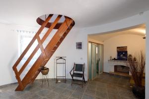 a staircase in a room with a chair at Villa Spyridoula studios on the Beach in Sidari