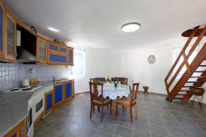 a kitchen with a table and chairs in a room at Villa Spyridoula studios on the Beach in Sidari
