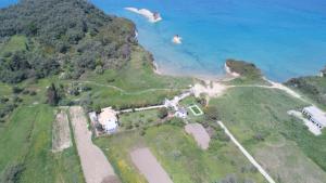 an aerial view of a house on a hill next to the ocean at Villa Spyridoula studios on the Beach in Sidari