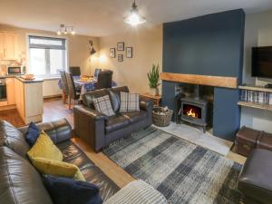 a living room with a couch and a fireplace at Mulgrave Cottage in Saltburn-by-the-Sea