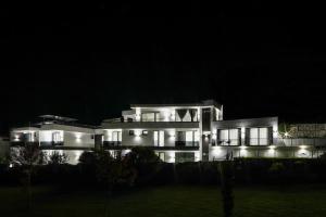 a large white building with lights at night at GRAFFIT Luxury houses in Ognyanovo