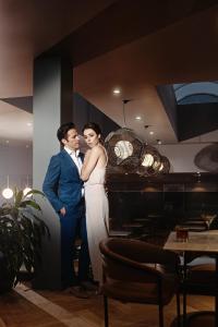 a bride and groom posing for a picture in a restaurant at Hotel St.Thomas in Montreal