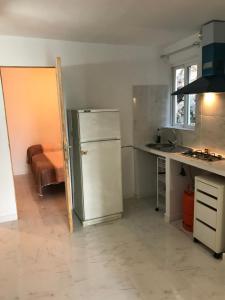 Una cocina con refrigerador y fregadero. en CASA-H -pequeño conjunto casas adosados, en La Caleta-Guardia