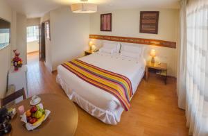 Postel nebo postele na pokoji v ubytování Taypikala Hotel Cusco + 37 fotografií