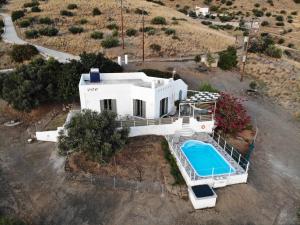 an aerial view of a white house with a swimming pool at Serendipity Crete in Agia Galini