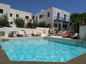 a large swimming pool in front of a house at Hotel Meltemi in Adamas