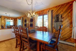a dining room with a wooden table and chairs at Phoenix I in Steamboat Springs