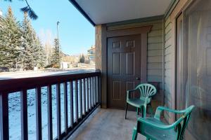a porch with two chairs and a door with a view at Phoenix I in Steamboat Springs